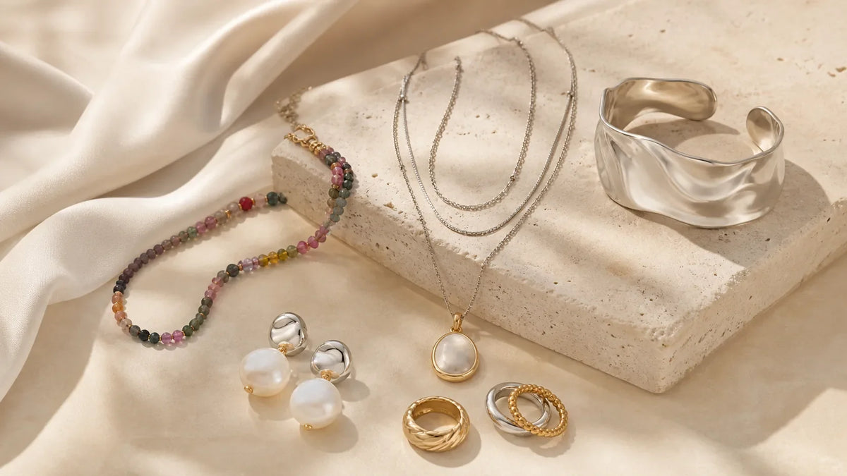 2026 jewelry trends with sculptural silver, colorful beads, pearls, layered necklaces, and mixed-metal rings