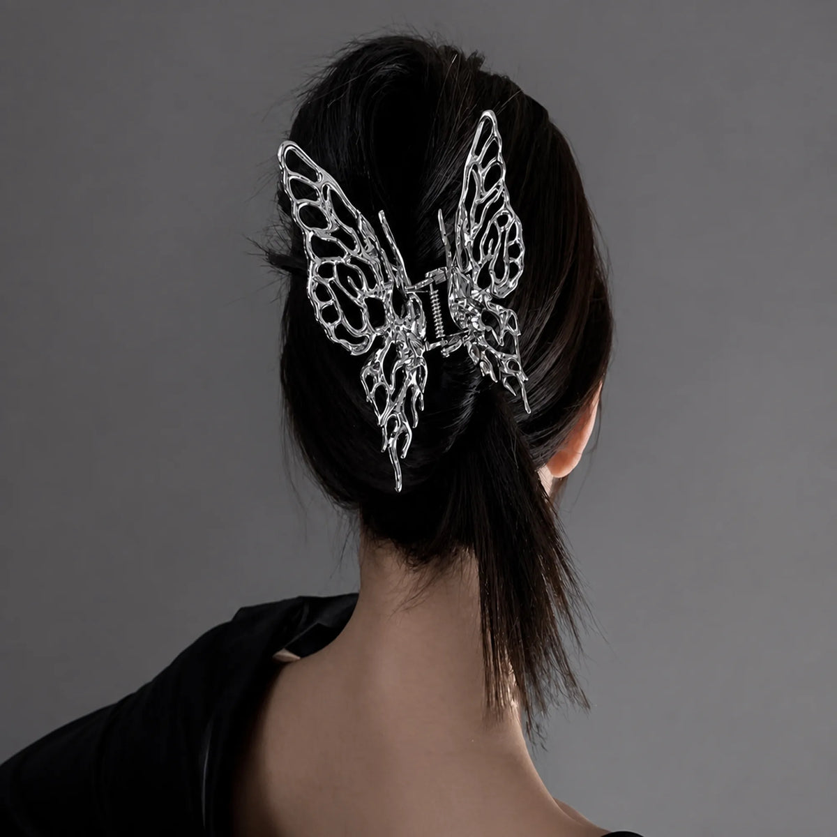 Selunyra Big Butterfly Claw Clip in a black low updo