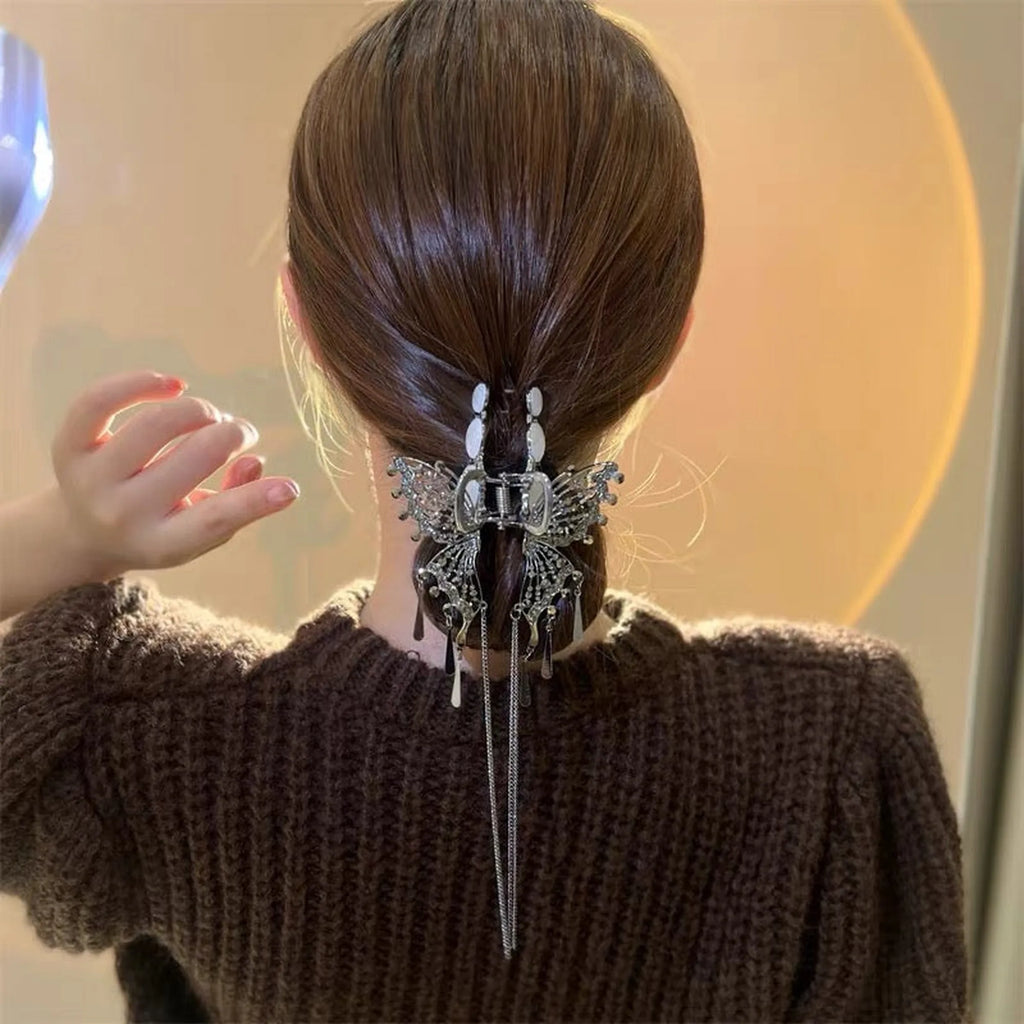 Selunyra black Butterfly Claw Clip in a low hairstyle