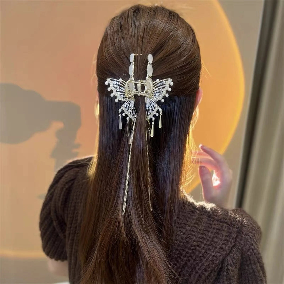Selunyra gold Butterfly Claw Clip in a half-up hairstyle
