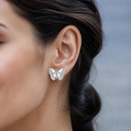 Selunyra silver butterfly earring worn on ear