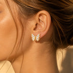 Selunyra gold butterfly earring worn on ear