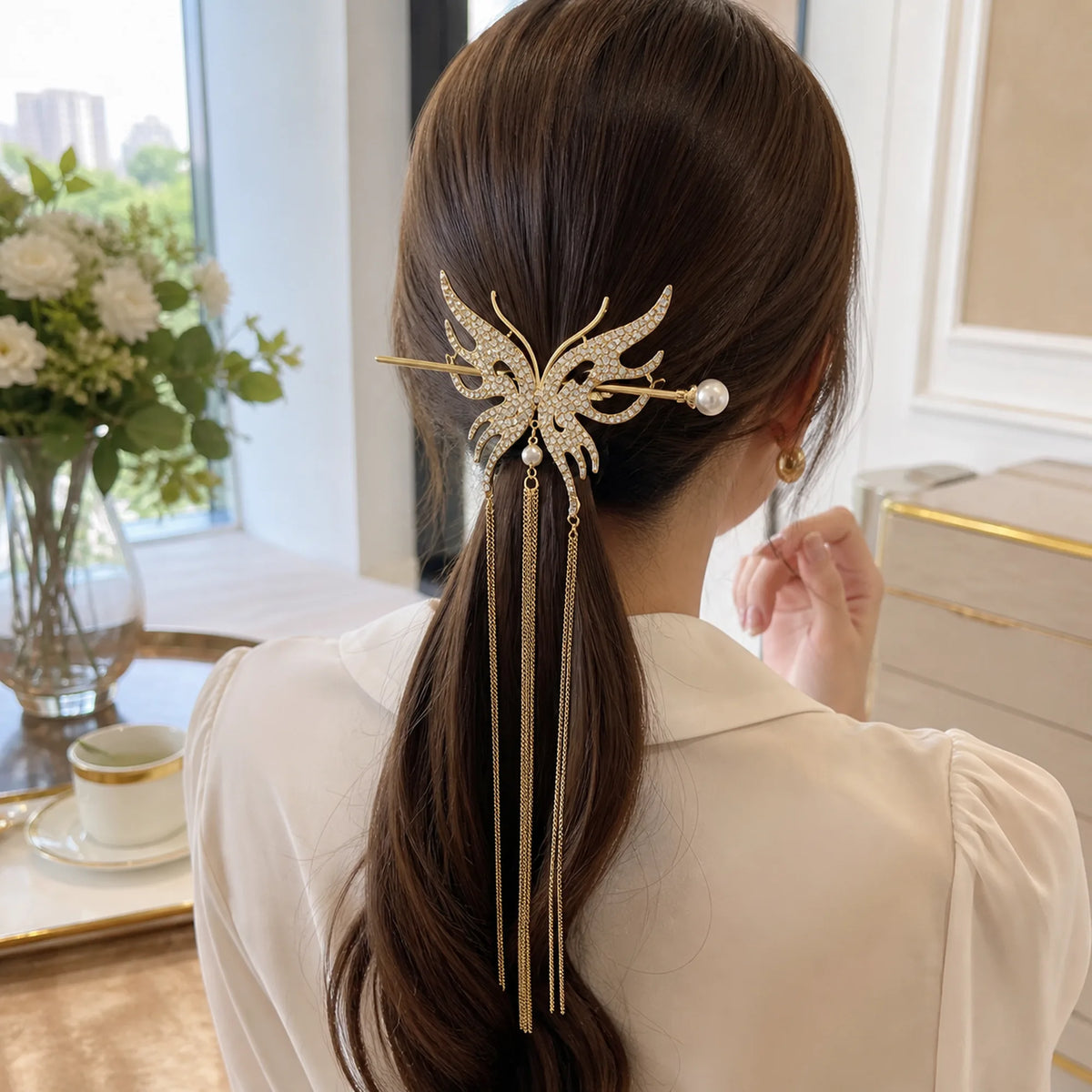 Selunyra gold butterfly tassel hair stick worn in daylight