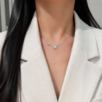 Selunyra Cheer double-butterfly necklace worn with an ivory blazer