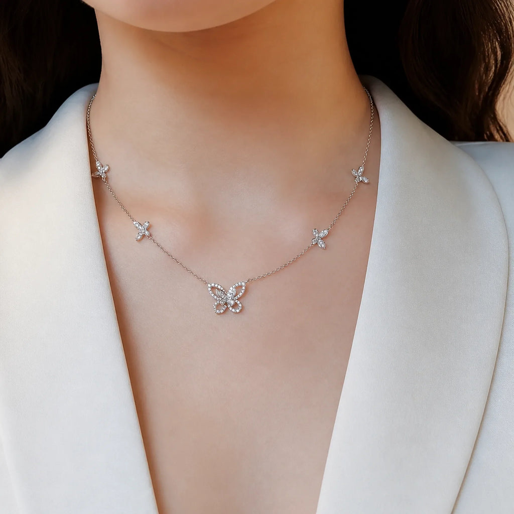 Selunyra Cheer five-butterfly necklace worn with an ivory blazer