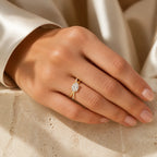 Selunyra gold Chica oval crossover ring worn on hand