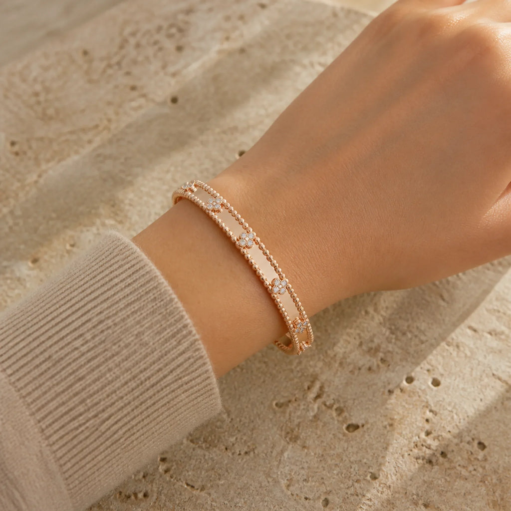 Selunyra rose gold clover bracelet worn on wrist