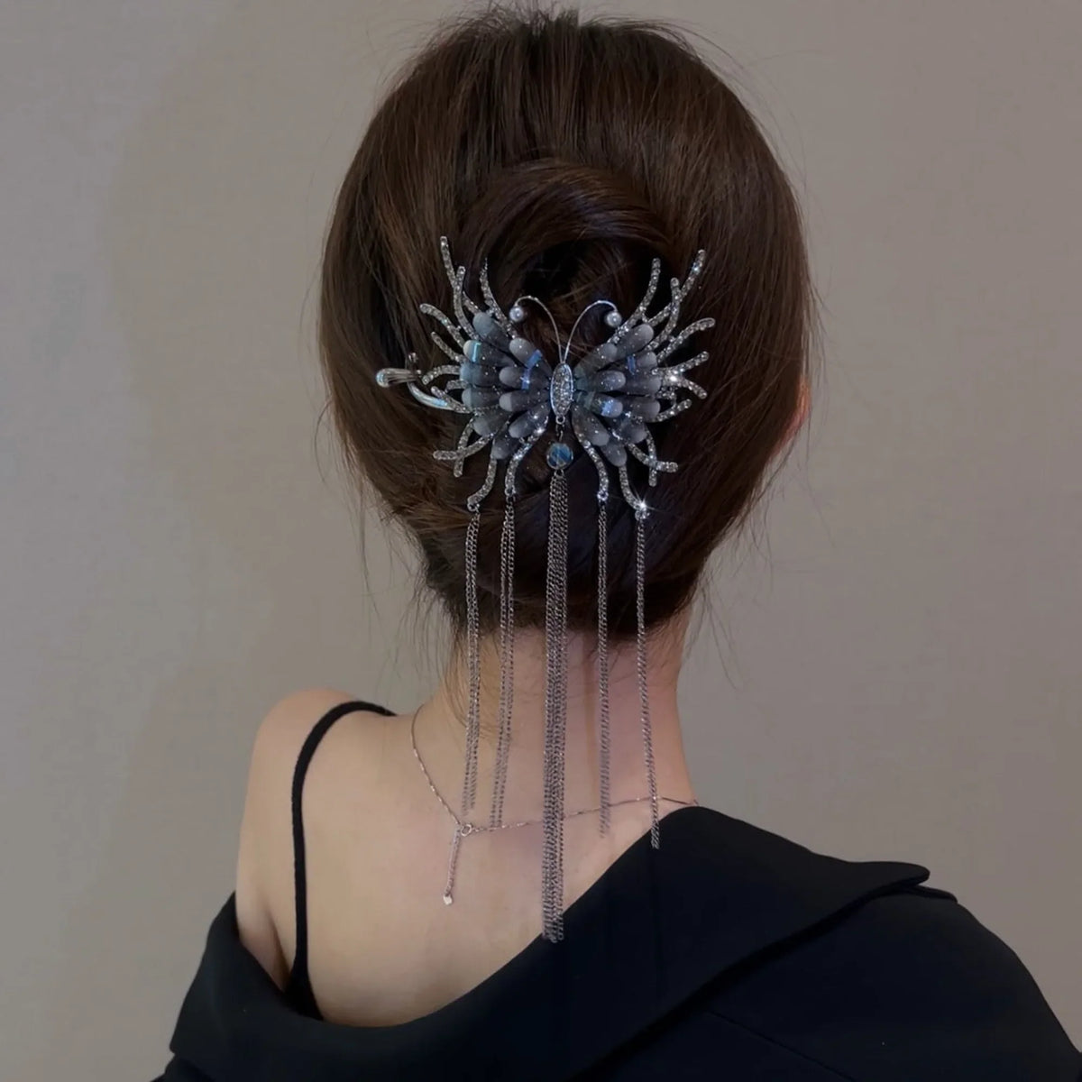 Selunyra dark butterfly tassel hairpin worn with an updo
