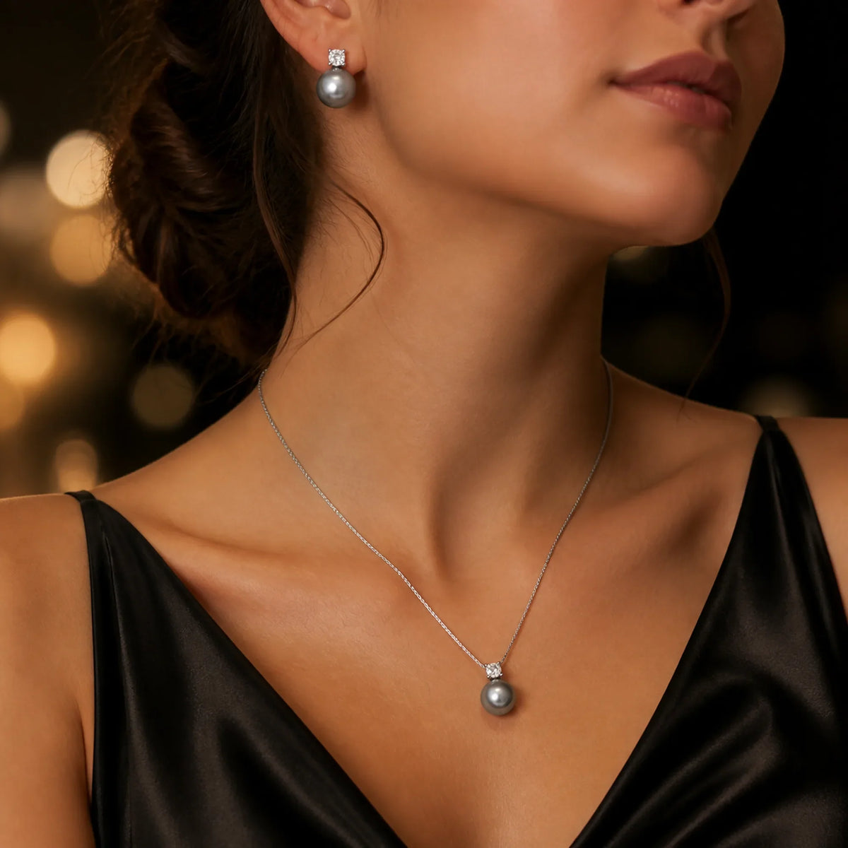 Selunyra Diana graphite pearl necklace and stud earring set worn in evening light