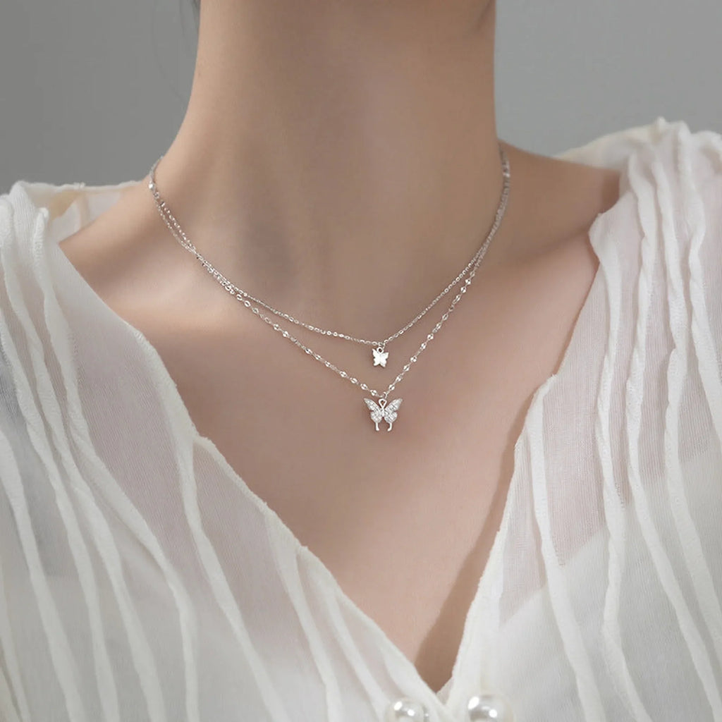 Selunyra S925 Double Butterfly Pendant Stacked Necklace worn with a blouse