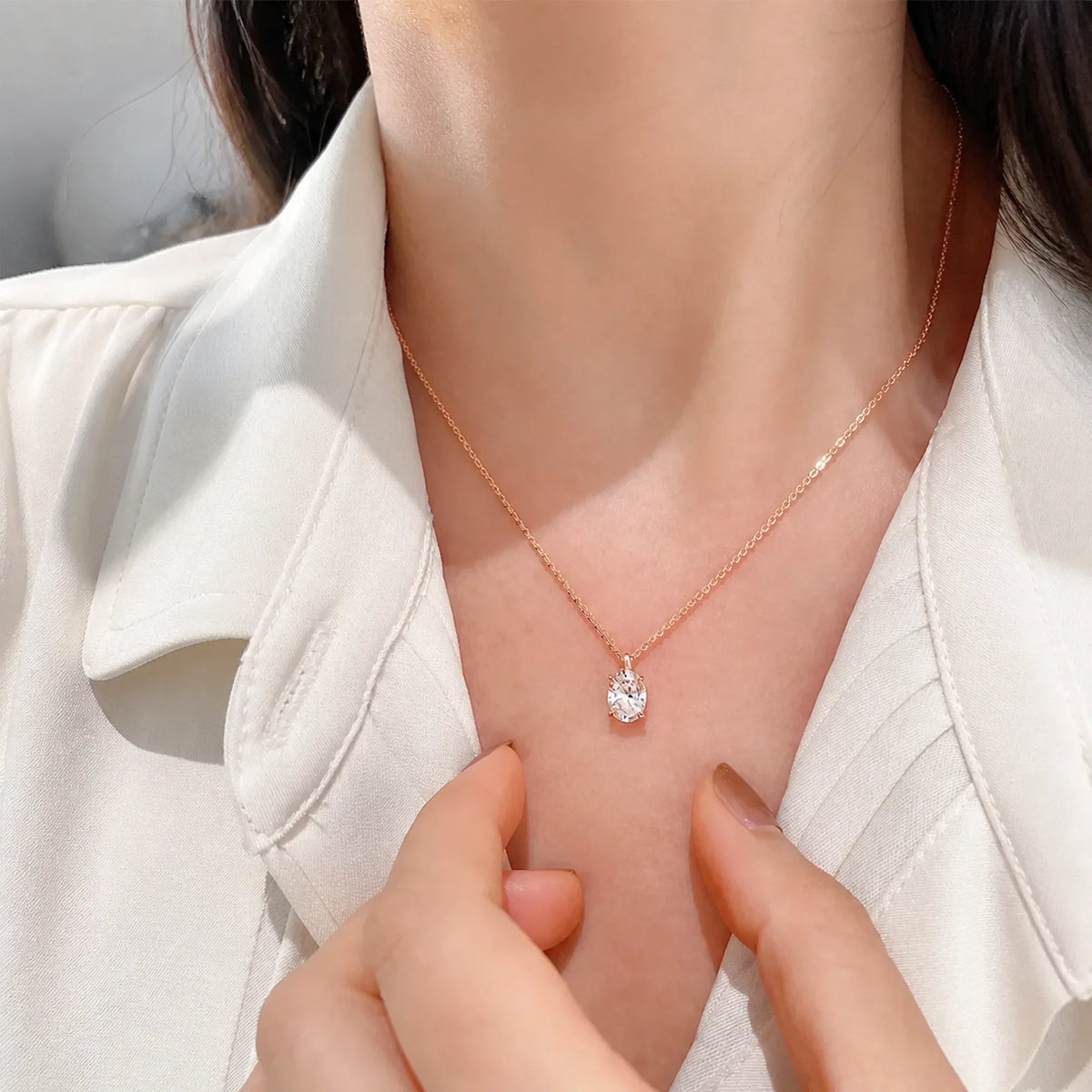 Selunyra Elena rose gold oval solitaire necklace worn with an ivory blouse