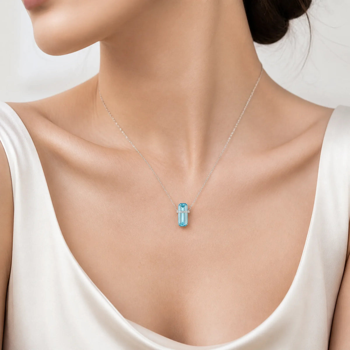 Selunyra Emerald Cut Blue D Necklace worn by model, studio view
