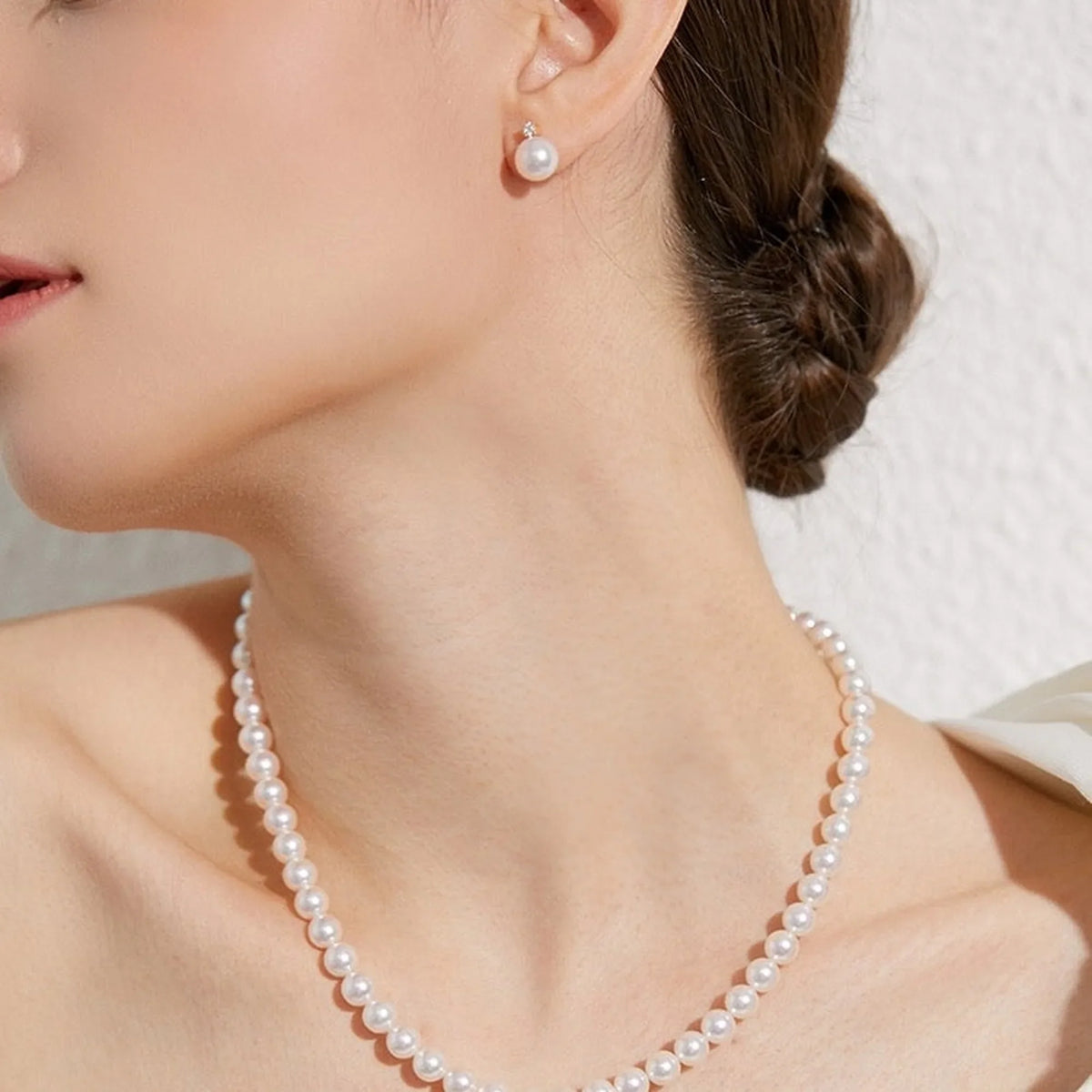 Selunyra Goria 8mm pearl necklace worn with an updo