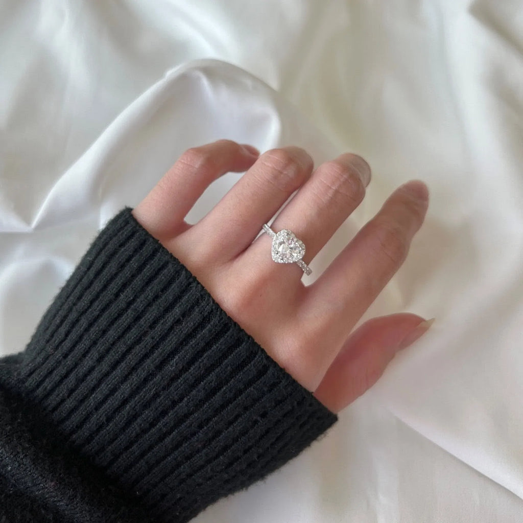 Selunyra clear heart halo ring worn close-up