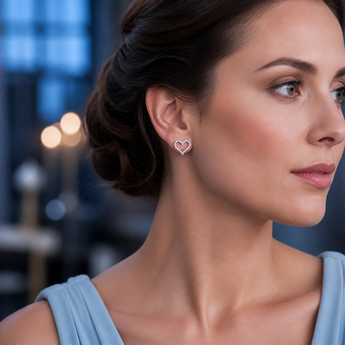 Selunyra silver pavé heart earrings worn with a blue dress