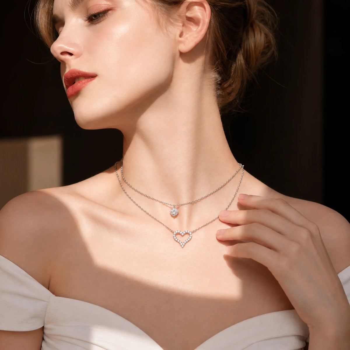 Selunyra layered silver heart necklace worn in warm sunlight