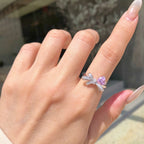 Selunyra pink heart and bow ring worn close-up