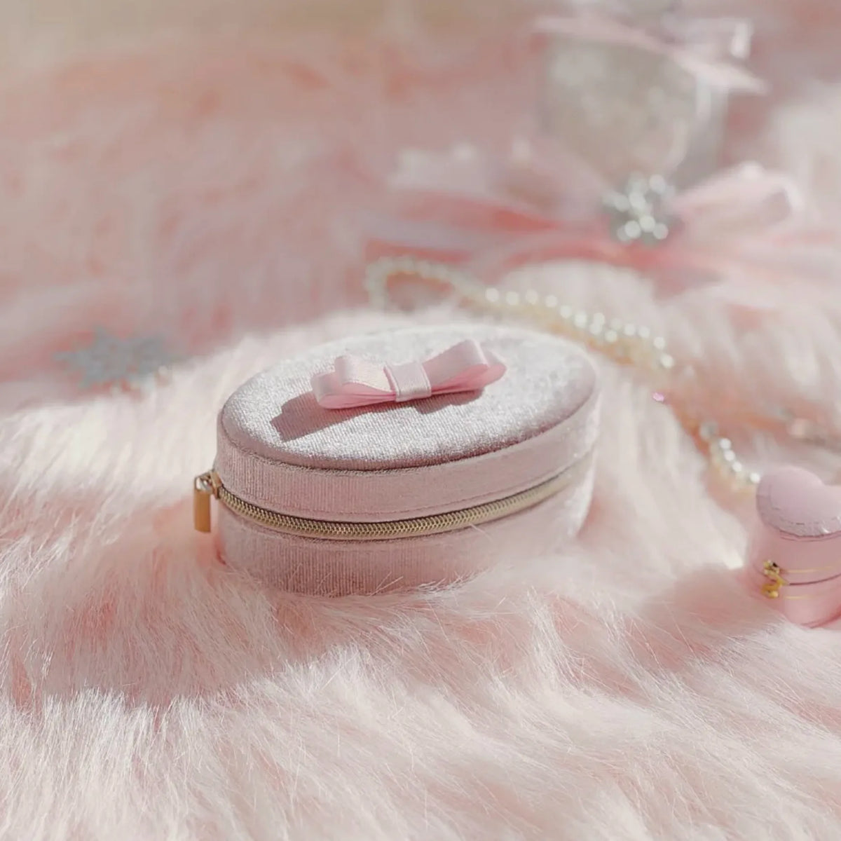 Selunyra pink bow travel jewelry box in a soft vanity setting