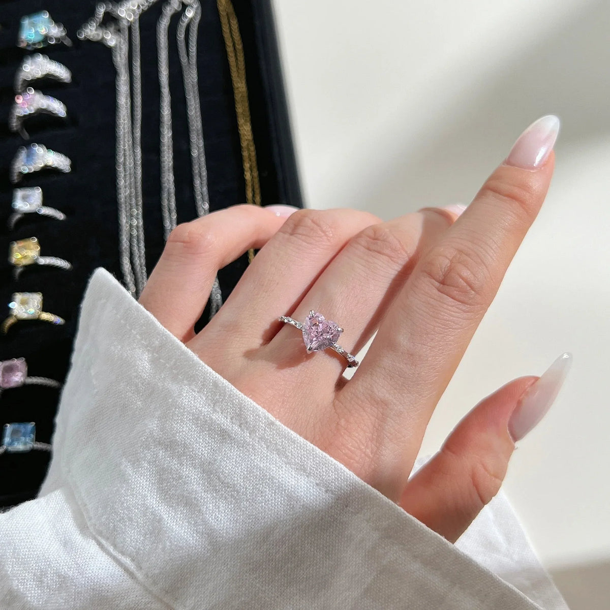Selunyra pink heart ring worn close-up
