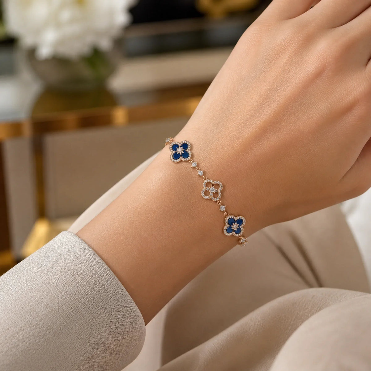 Selunyra Royal Blue Cleef gold bracelet worn on wrist