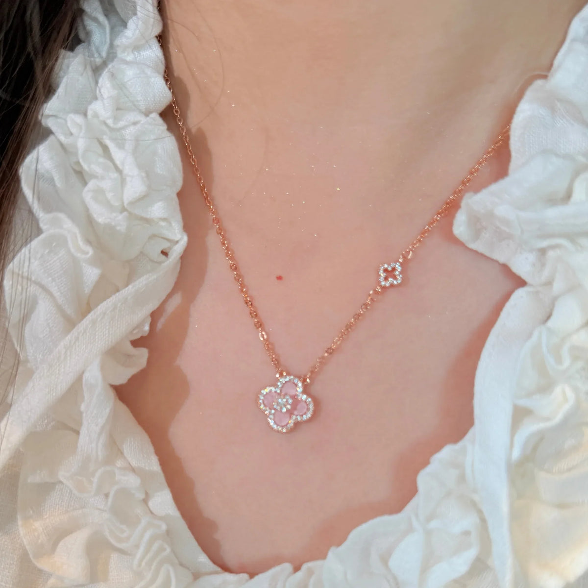 Selunyra Sakura Cleef pink necklace worn with white blouse