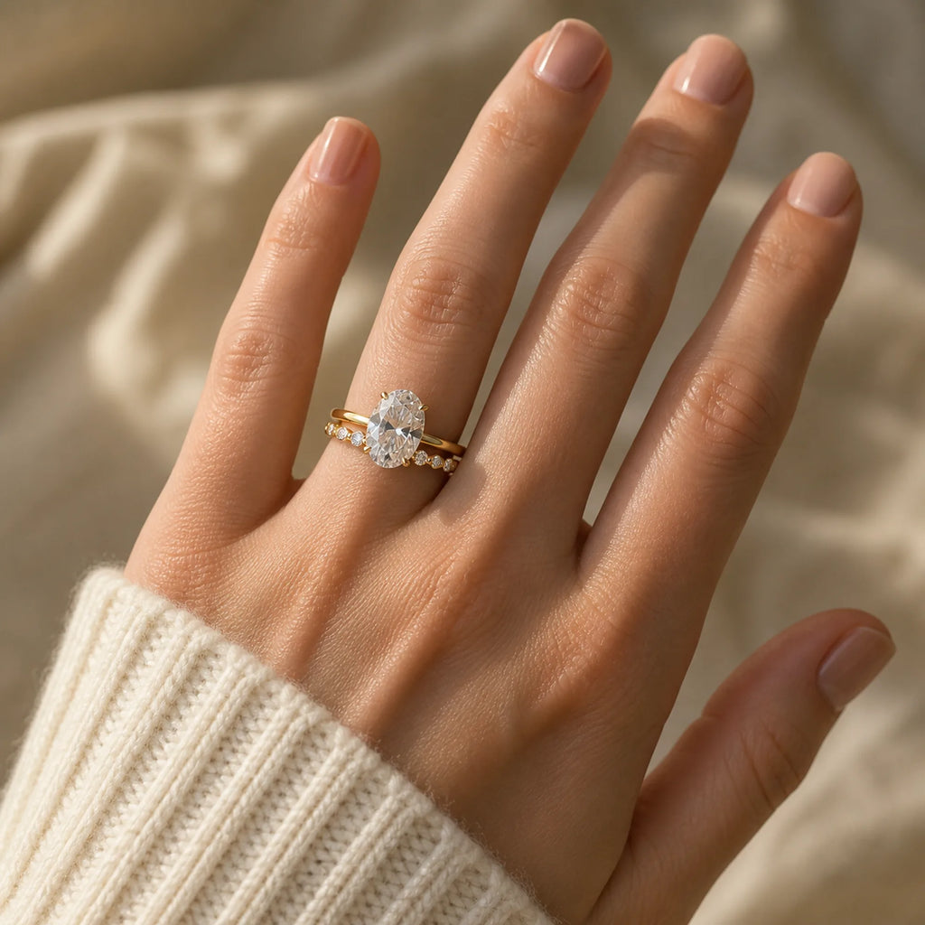Selunyra Sara oval solitaire and curved band worn with ivory knit