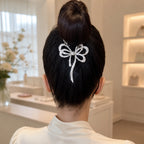 Selunyra silver rhinestone butterfly claw clip worn in an updo