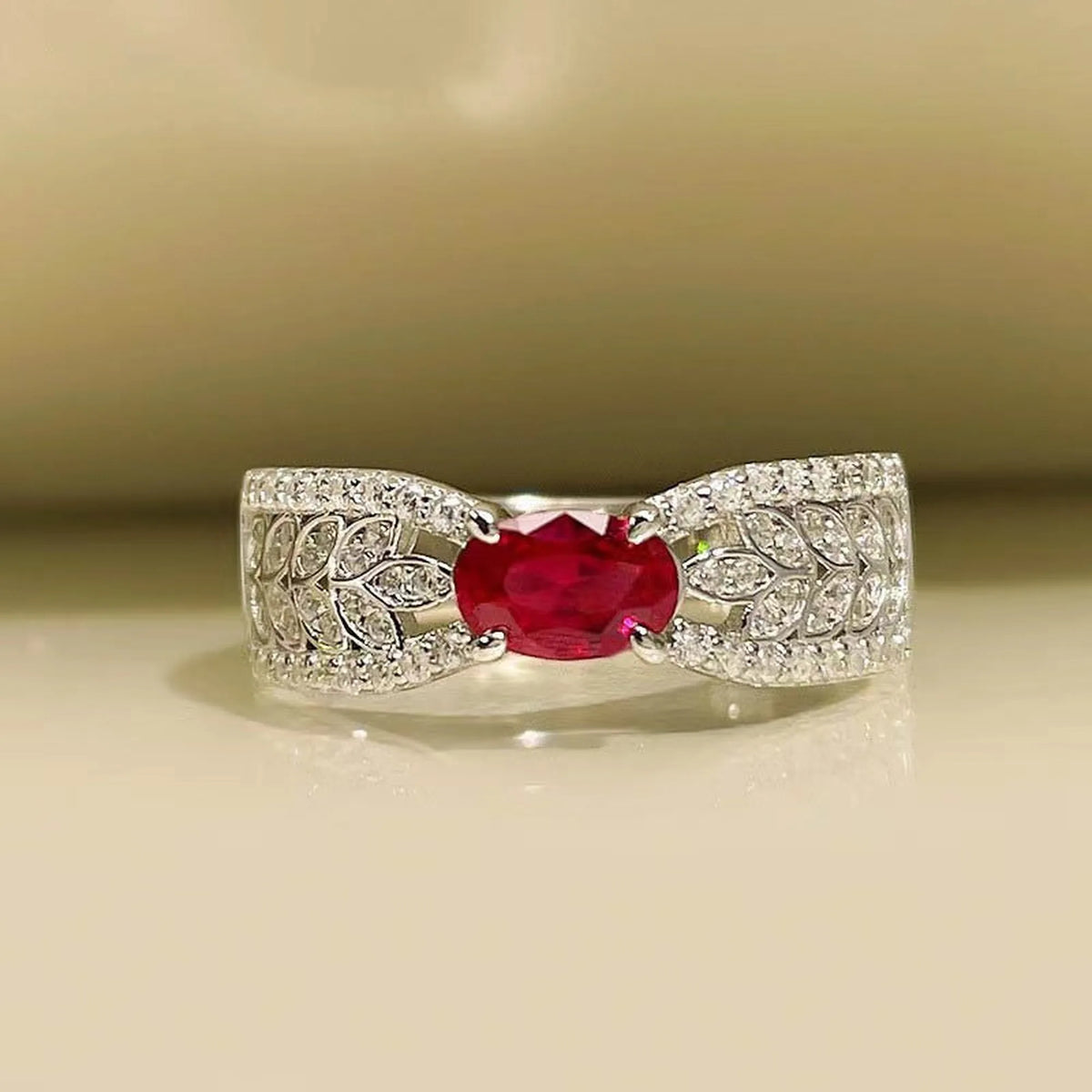Selunyra Zeus Ring with oval ruby-red stone and leaf motif