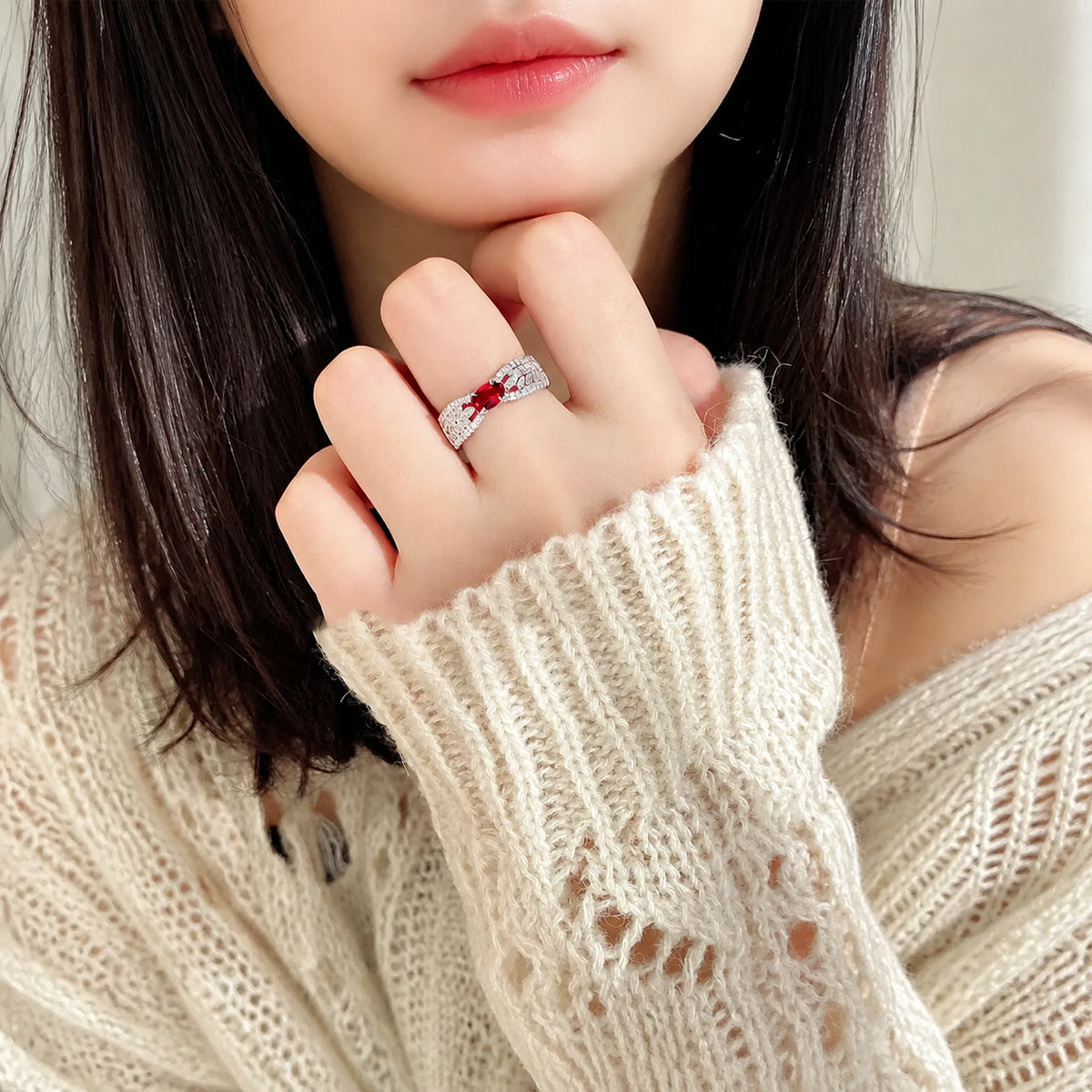 Selunyra Zeus Ring styled with a cream knit sleeve